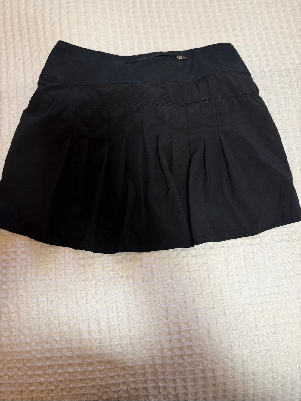 Roadrunner Black Pleated Women’s running skirt with shorts underneath.
